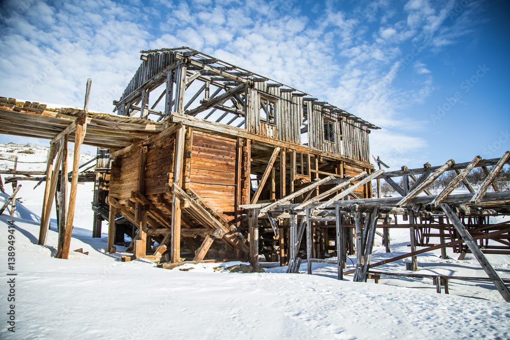 An old, abandoned copper mine building in the snowy Norway landscape An old, abandoned copper mine building in the snowy Norway landscape
