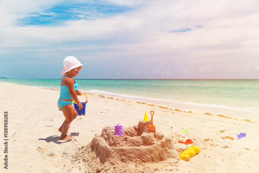 cute little girl play with sand on beach cute little girl play with sand on beach