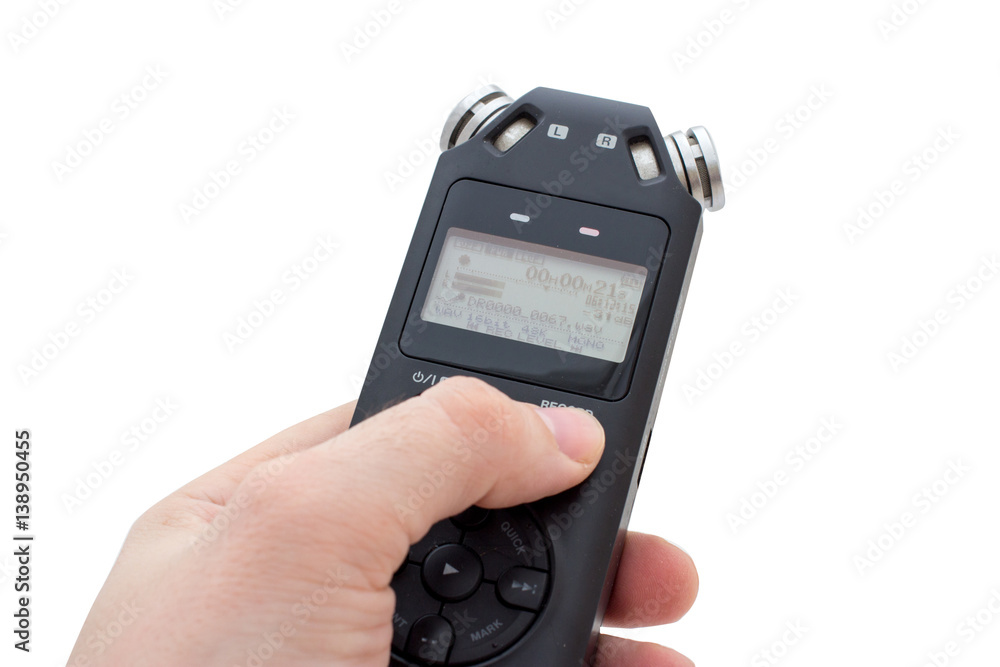 Male hand holding Audio Recorder using for documenting sound Male hand holding Audio Recorder using for documenting sound