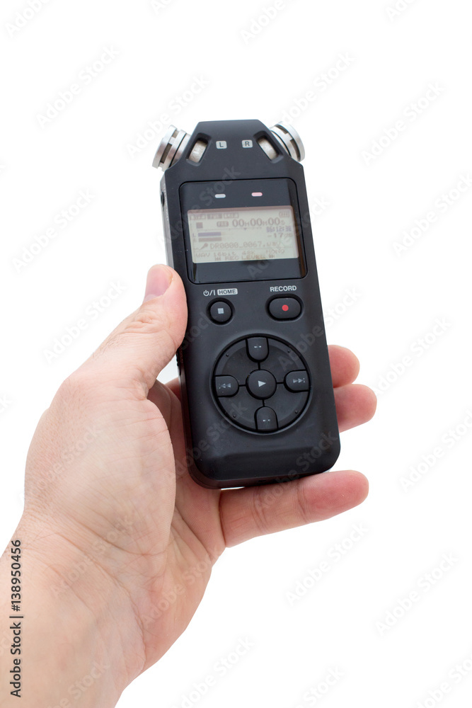 Male hand holding Audio Recorder using for documenting sound Male hand holding Audio Recorder using for documenting sound