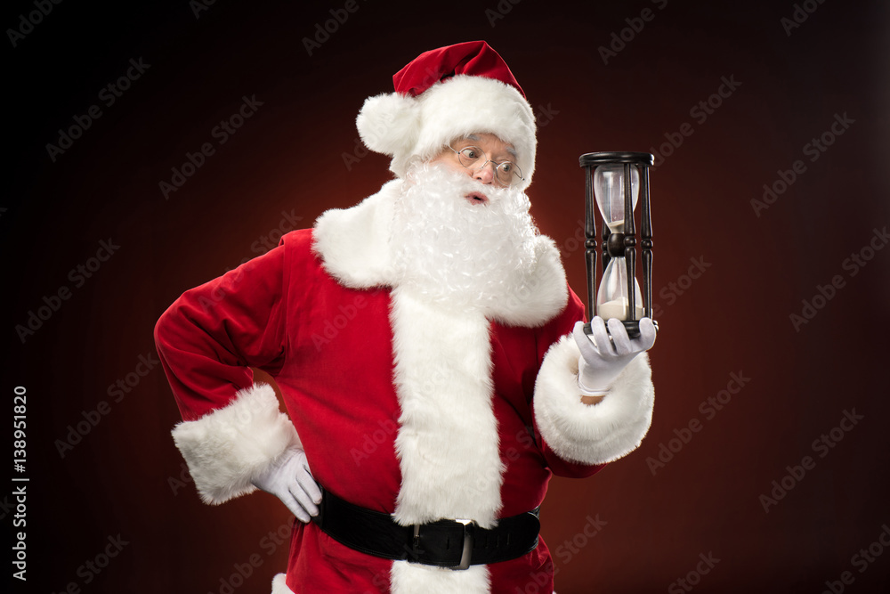Santa Claus holding hourglass Santa Claus holding hourglass