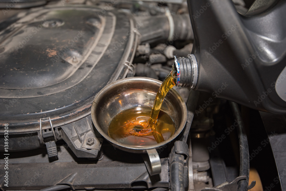 oil change, pouring oil to car engine oil change, pouring oil to car engine