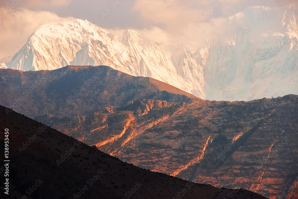 Snowy peaks at sunset in the Himalayan mountains. Nepal. Kingdom of Mustang.