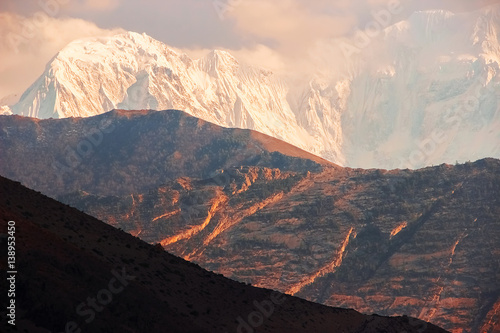 Snowy peaks at sunset in the Himalayan mountains. Nepal. Kingdom of Mustang.