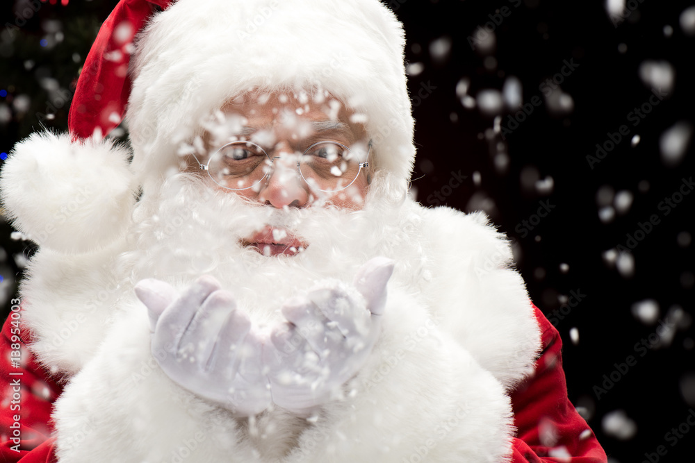 Santa Claus blowing snowflakes Santa Claus blowing snowflakes