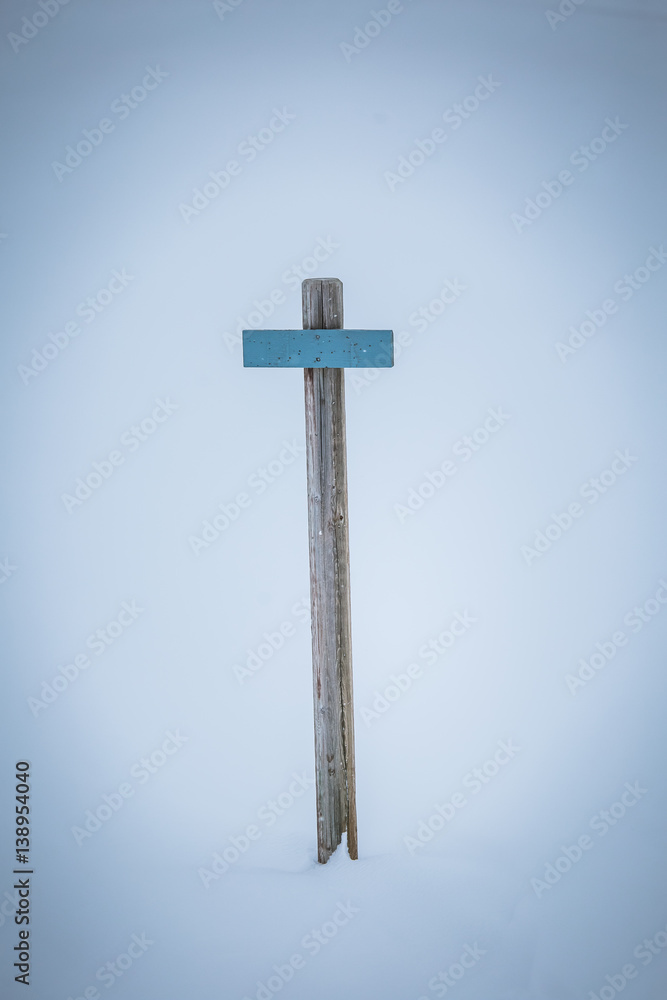 A beautiful wooden sign pole in the snow