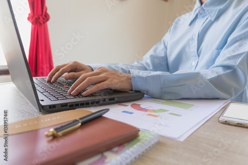 Businessman working on project in laptop at office desk. Concept investor and finance morning light. Concept business and financial