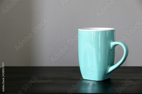 Green coffee cup on the table

