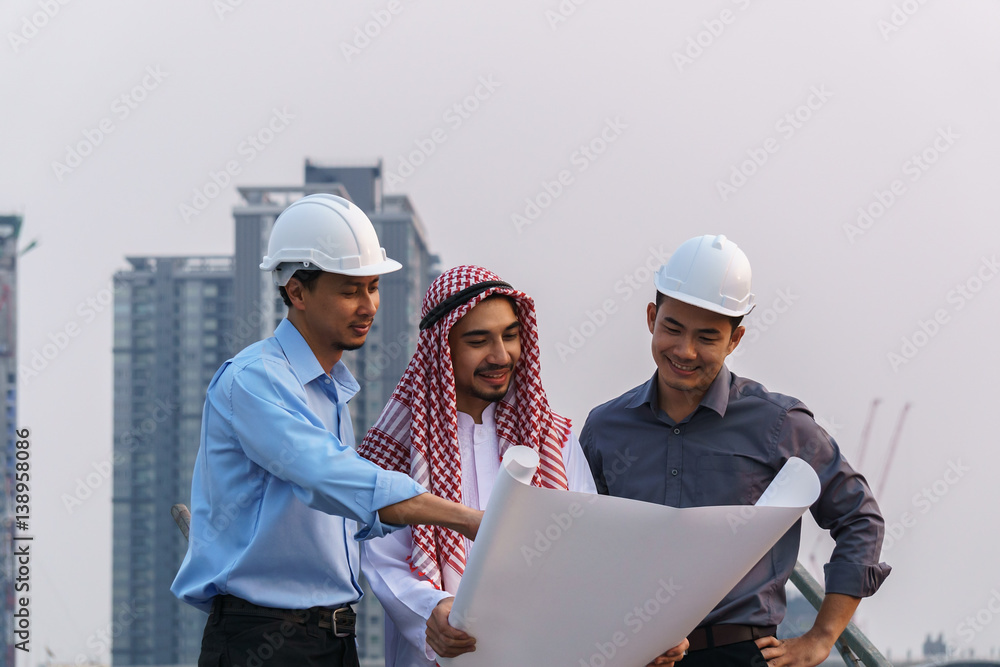 business people group on meeting and presentation with construction engineer architect looking building model and blueprint plans business people group on meeting and presentation with construction engineer architect looking building model and blueprint plans