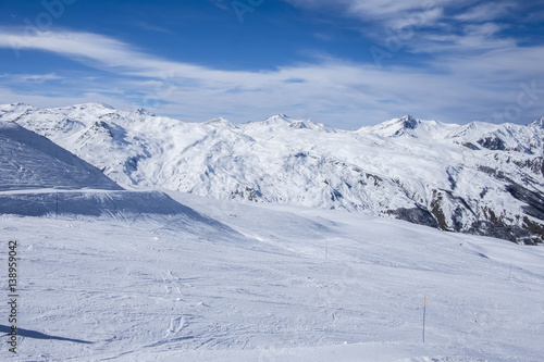 A wide piste, on a clear sunny day in Meribel, in the French Alps