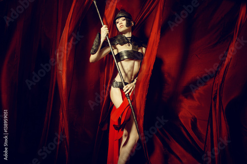 Woman in armour and helmet holding spear 