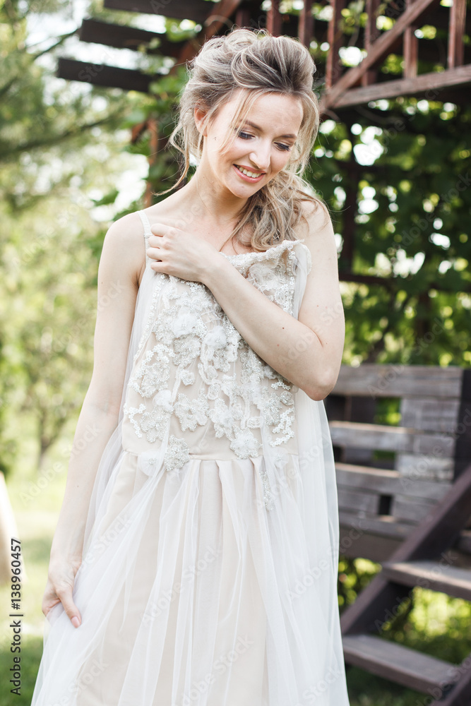 Wedding morning: beautiful bride trying on a wedding dress Wedding morning: beautiful bride trying on a wedding dress
