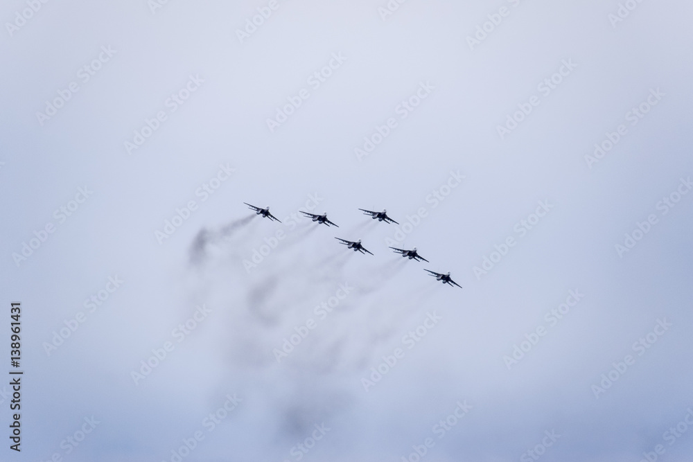 Obraz premium Air show in the sky above the Krasnodar airport flight school. Airshow in honor of Defender of the Fatherland. MiG-29 in the sky.