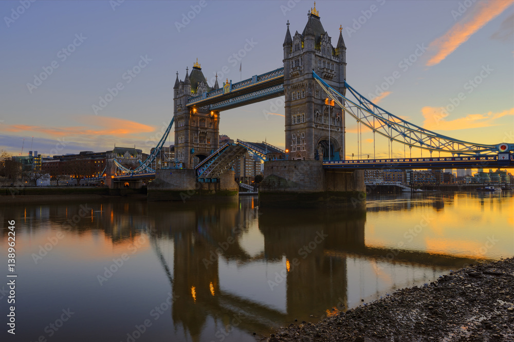 The Tower Bridge lifting during sunrise. Shot from the Southwark side of River Thames.