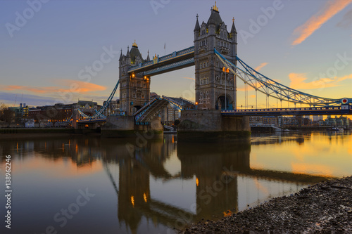 The Tower Bridge lifting during sunrise. Shot from the Southwark side of River Thames.