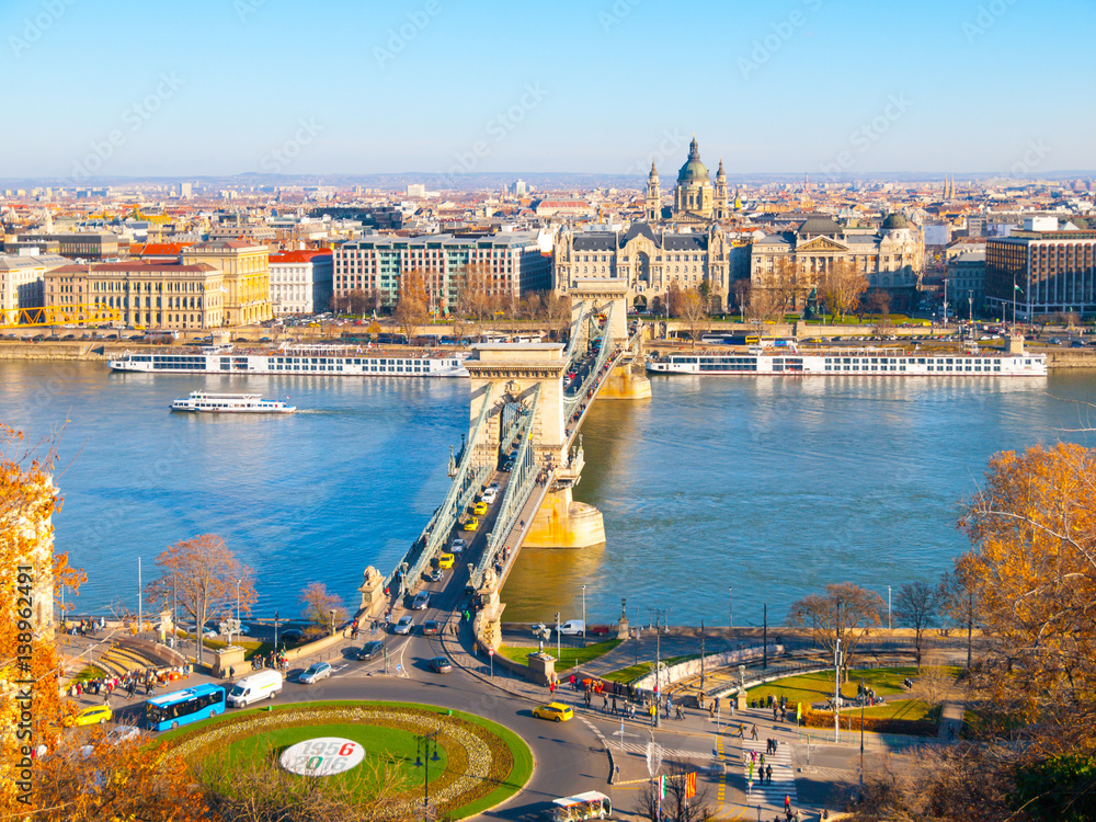 Famous Chain Bridge over Danube River and Saint Stephen's Basilica view from Buda Castle on sunny autumn day in Budapest, capital city of Hungary, Europe. UNESCO World Heritage Site