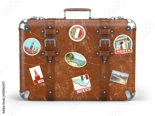 Old suitcase baggage with travel stickers isolated on white background. photo