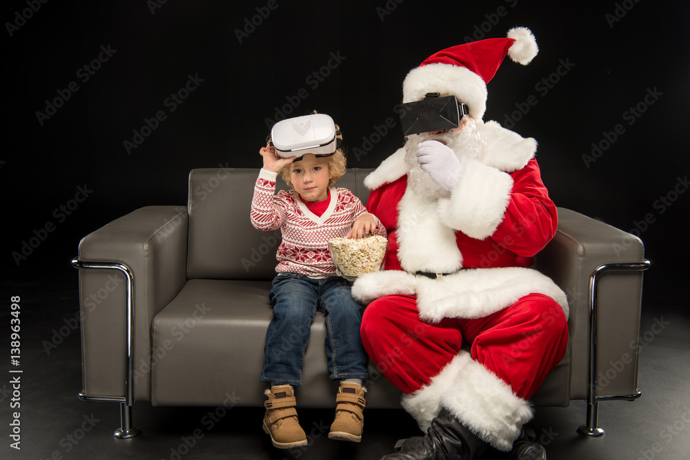 Santa Claus and child in virtual reality headsets Santa Claus and child in virtual reality headsets