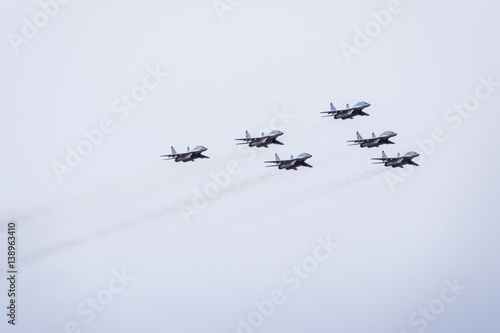 Air show in the sky above the Krasnodar airport flight school. Airshow in honor of Defender of the Fatherland. MiG-29 in the sky. photo