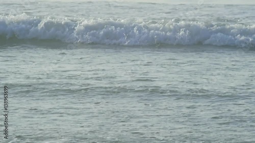 braking waves near ocean beach photo