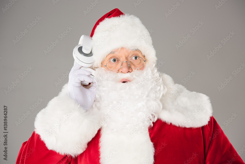 Santa Claus listening music with headphones