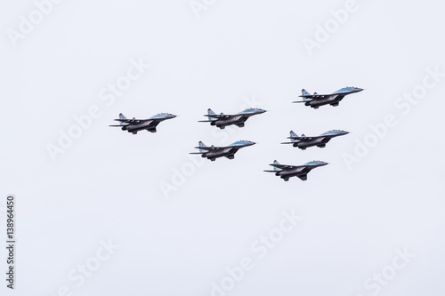 Air show in the sky above the Krasnodar airport flight school. Airshow in honor of Defender of the Fatherland. MiG-29 in the sky. photo