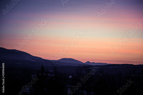 A beautiful, artistic, colorful sunset in Norway above mountains © dachux21