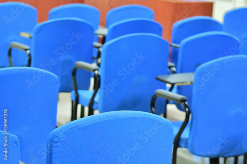 Empty blue chair of a classroom 