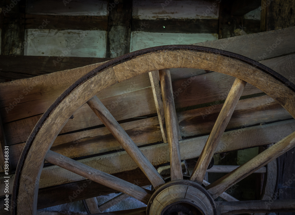 The old wheel of a cart in barn