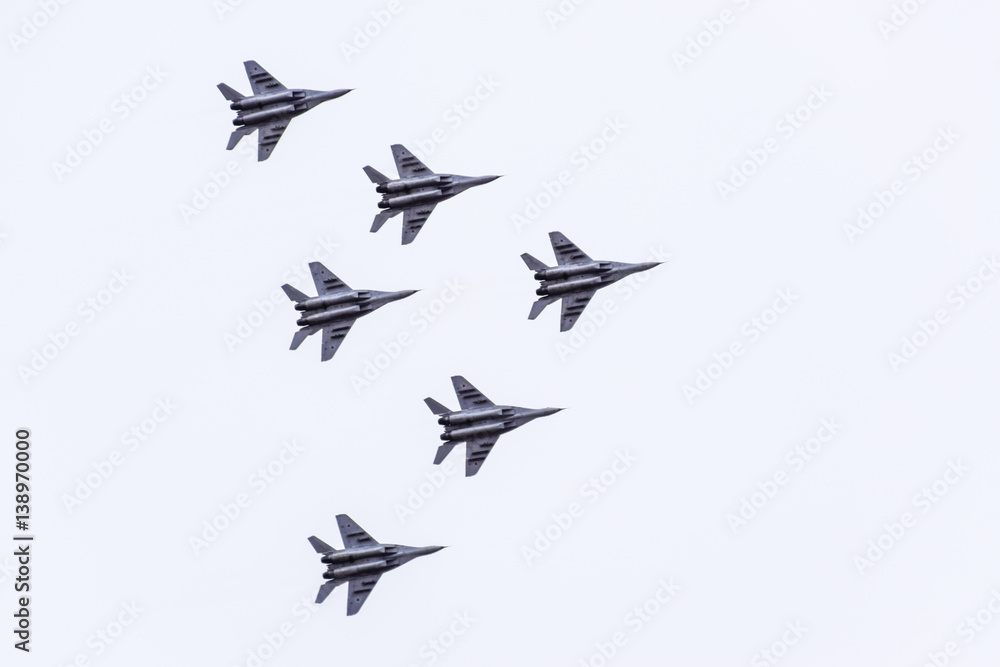 Air show in the sky above the Krasnodar airport flight school. Airshow in honor of Defender of the Fatherland. MiG-29 in the sky. - obrazy, fototapety, plakaty 