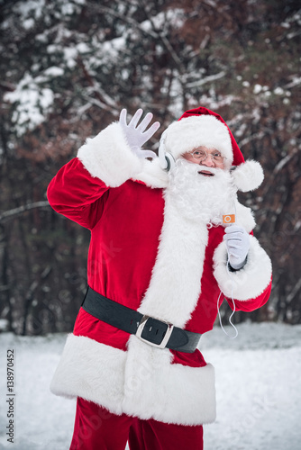 Santa Claus listening to music in headphones © LIGHTFIELD STUDIOS