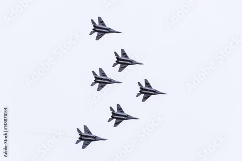 Air show in the sky above the Krasnodar airport flight school. Airshow in honor of Defender of the Fatherland. MiG-29 in the sky. photo