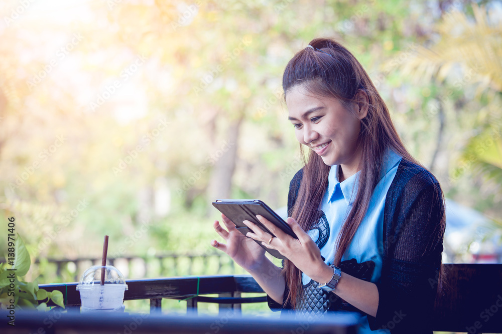 Young woman using tablet in coffee shop Young woman using tablet in coffee shop