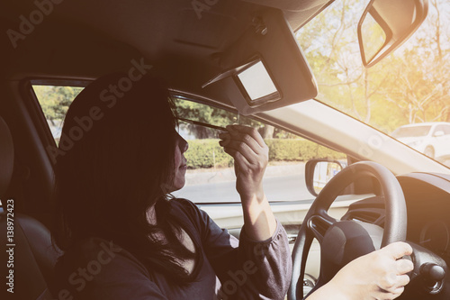 Wallpaper Mural Woman makeup her face using eyebrow pencil while driving car, unsafe behavior Torontodigital.ca