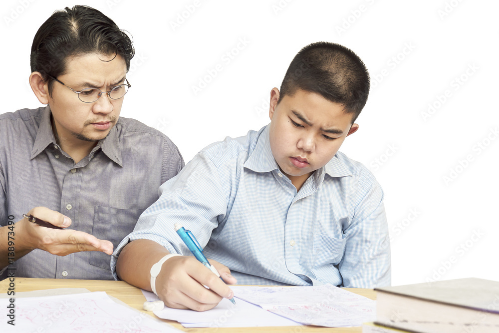 Asian father teaching homework to his 14 years son seriously Asian father teaching homework to his 14 years son seriously