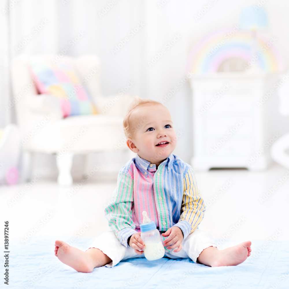 Baby boy with bottle drinking milk or formula Baby boy with bottle drinking milk or formula