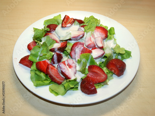 Summer salad of fresh strawberries with grilled brine cheese and yoghurt sauce and balsamic vinegar, strawberries, yoghurt, fresh green salad