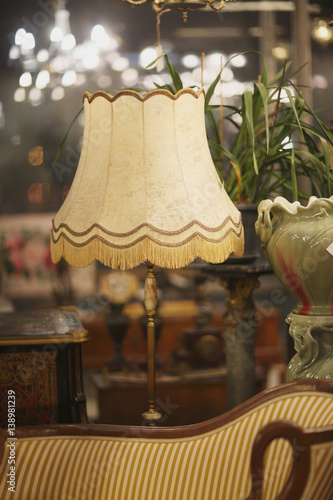 Vintage table lamp with silk shade in the antique salon/