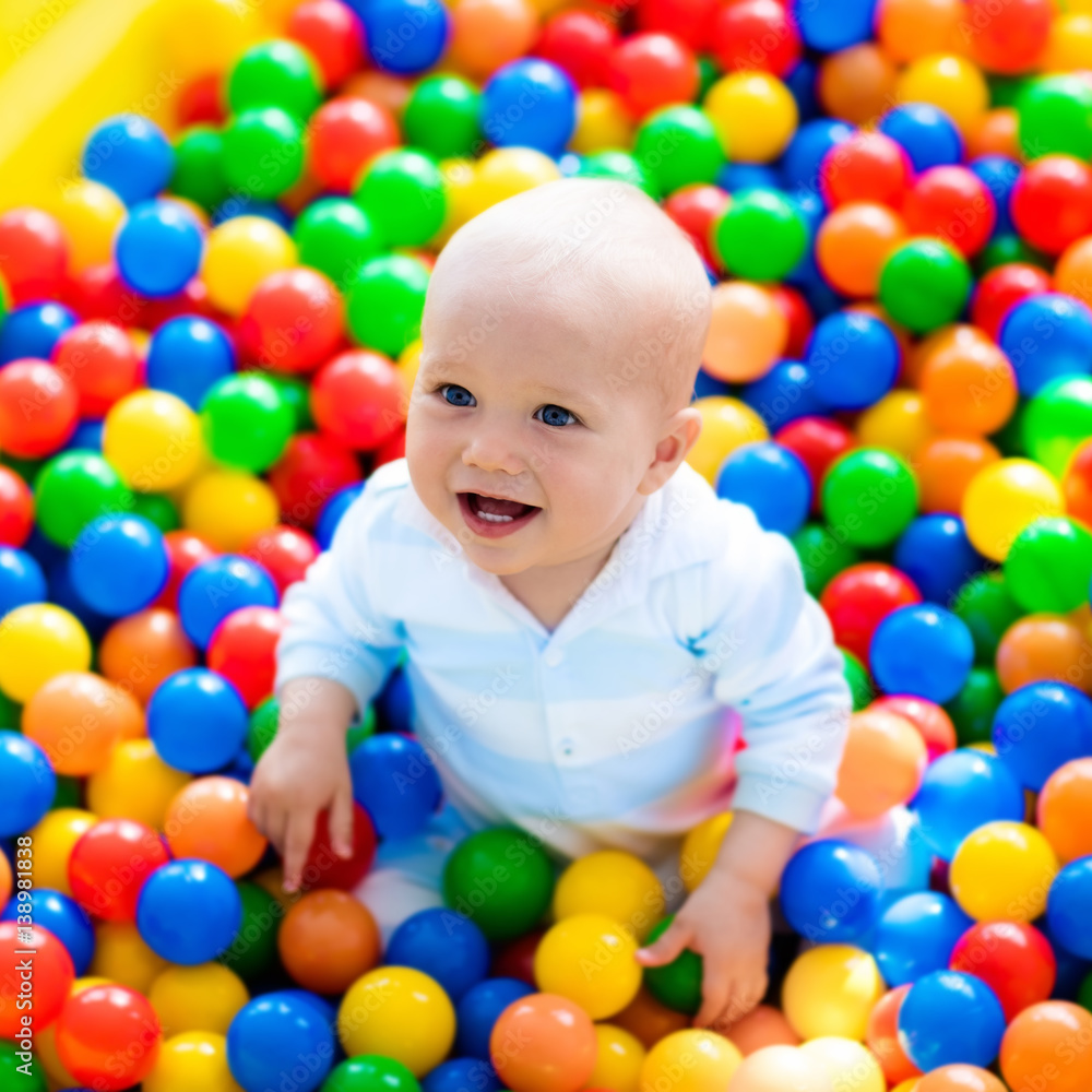 Child playing in ball pit on indoor playground Child playing in ball pit on indoor playground