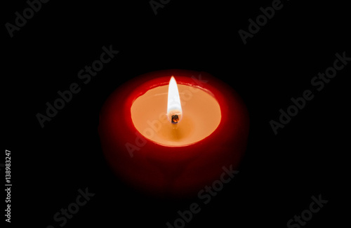 Red candle isolated on a black