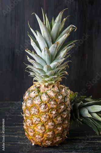 Pineapple fruit against dark wooden background