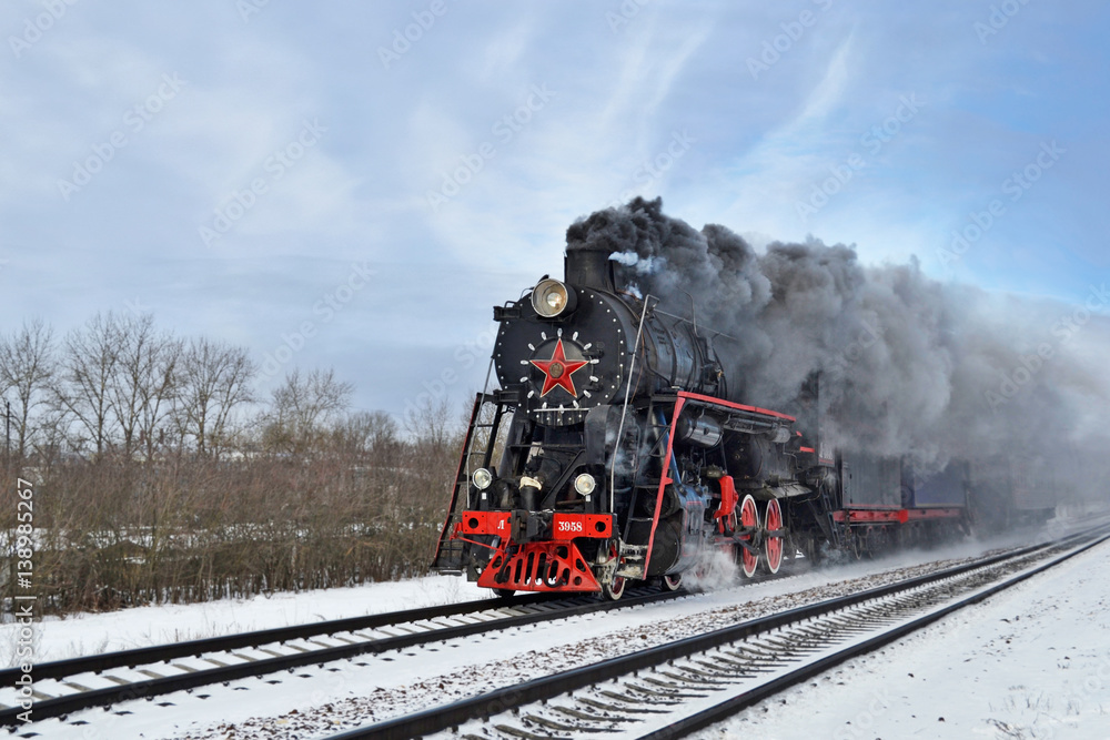 Steam train puffing along the tracks Steam train puffing along the tracks
