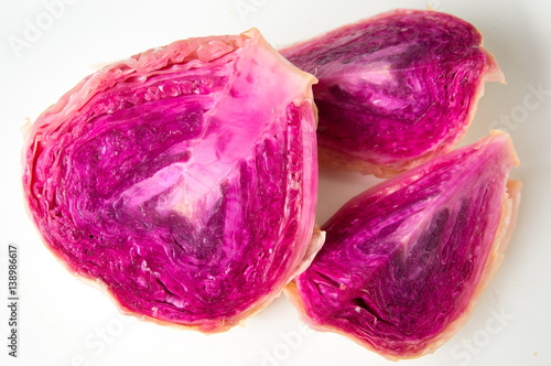 Red sour cabbage slices on white