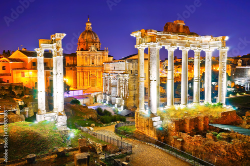 Photography View of the roman ruins at night in Rome, Italy.