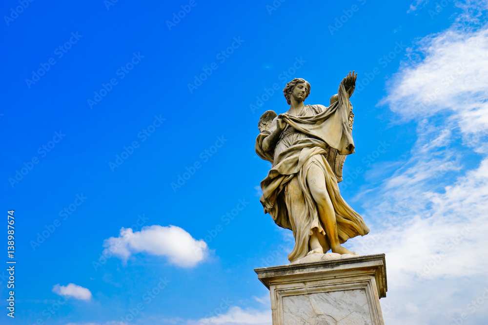 The statue of angel figure on the Aelian Bridgein in Rome in a sunny day.