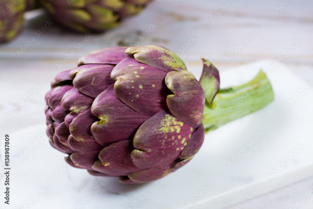 Fototapeta premium Fresh big Romanesco artichokes green-purple flower heads ready to cook