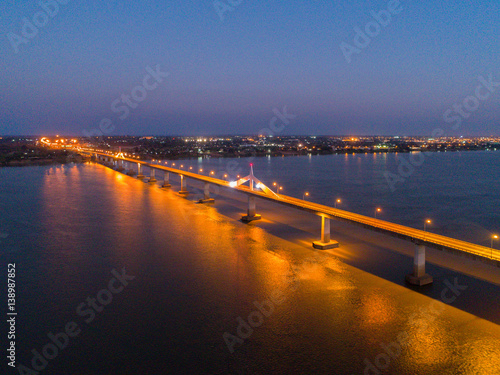 Aerial view of Bridge over khong river at night - bridge in the night of Second Thai–Lao Friendship Bridge.
over the Mekong connects Mukdahan Province in Thailand with Savannakhet in Laos. photo