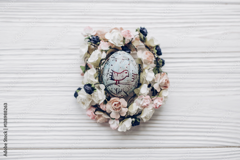 easter egg with chick ornaments in floral nest with flowers on rustic white wooden background flat lay. happy easter greeting card. space for text, top view. soft light easter egg with chick ornaments in floral nest with flowers on rustic white wooden background flat lay. happy easter greeting card. space for text, top view. soft light