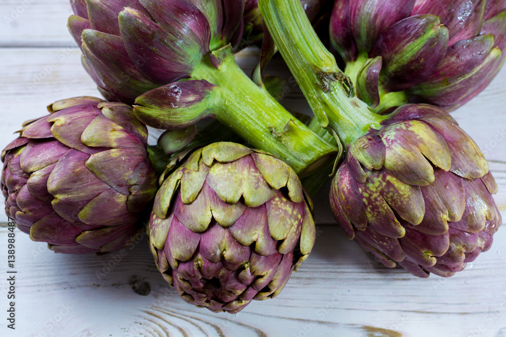 Fresh big Romanesco artichokes green-purple flower heads ready to cook Fresh big Romanesco artichokes green-purple flower heads ready to cook