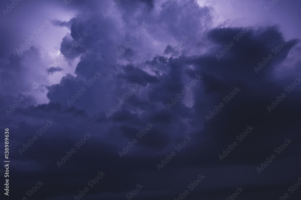 Thunderstorm, dark blue three-dimensional clouds illuminated by lightning flashes Thunderstorm, dark blue three-dimensional clouds illuminated by lightning flashes